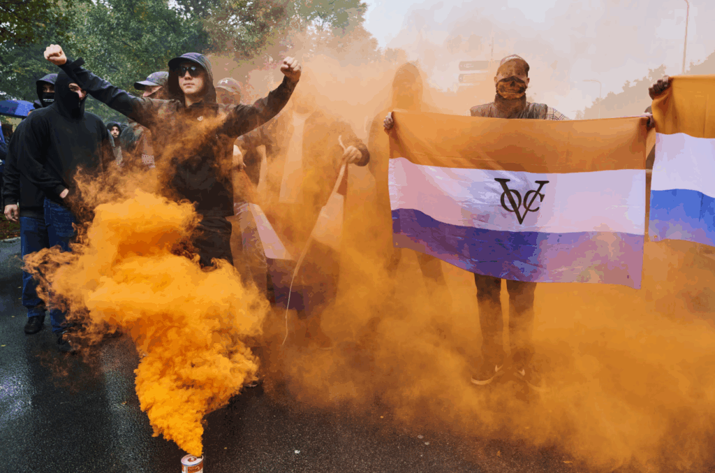 September 2025, anti-immigration protest with white nationalist flag and smoke bombs. Many wore deathmask headcoverings and uttered racist slogans